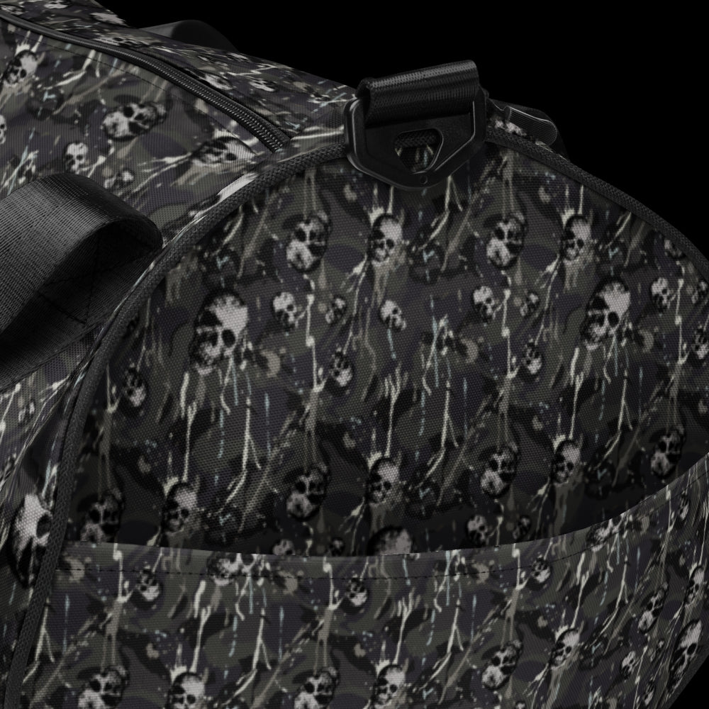 a duffel gym bag with a camo, paint splatter, and gritty skulls pattern in grey camo shades