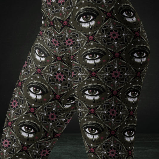 Brown kaleidoscope like leggings with crying eyes and emo symbols