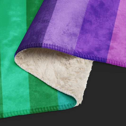 A rainbow colored sherpa blanket featuring skulls and stripes in the format on the American flag