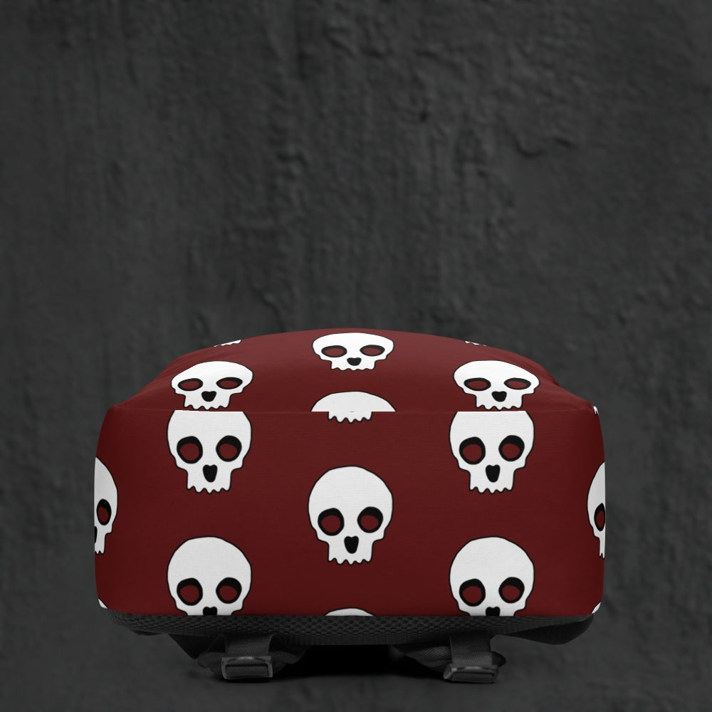 a backpack with a large skull pattern on deep red