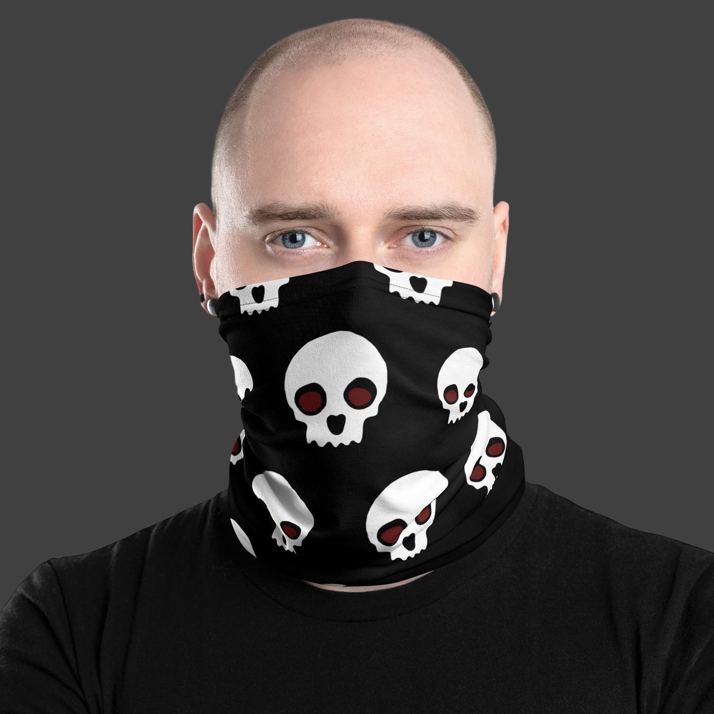 Man wearing a black neck gaiter with skulls over his face