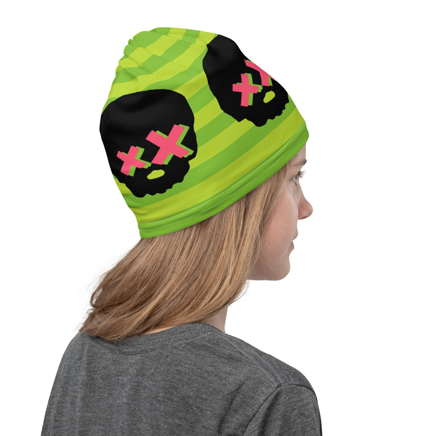 woman wearing green striped neck gaiter with pink x-eyed skulls as a beanie
