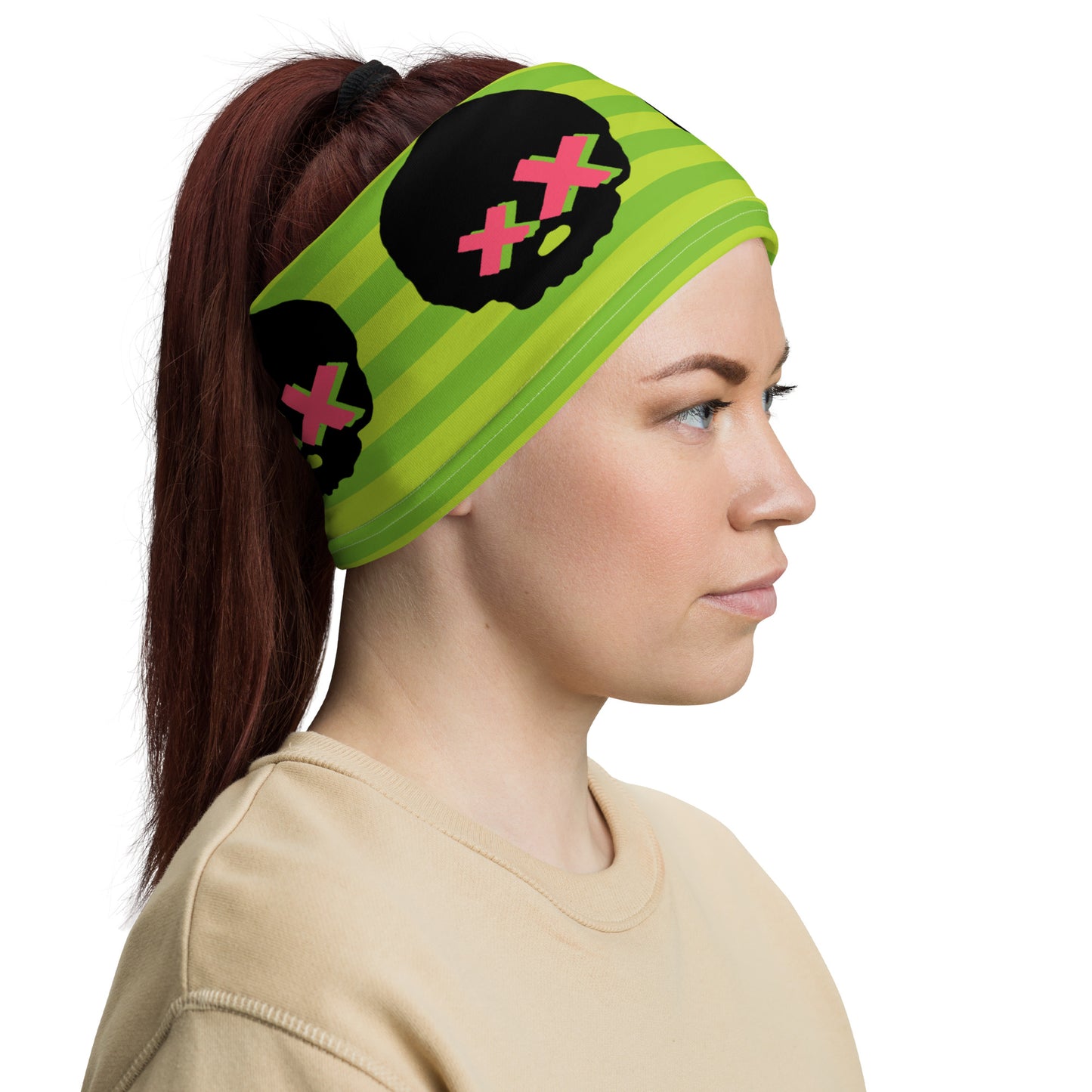 woman wearing green striped neck gaiter with pink x-eyed skulls as a head bandana