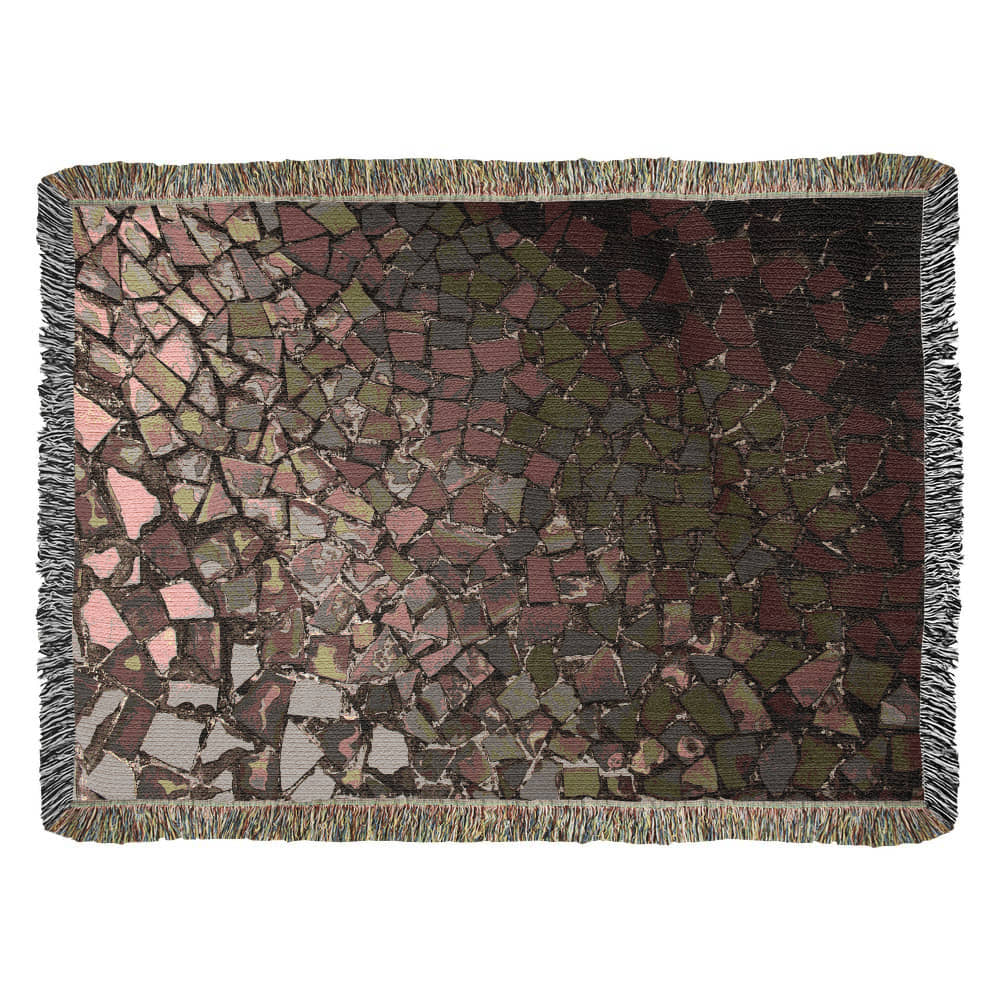 A woven blanket with deep red, black and lighter color shattered mosaic image