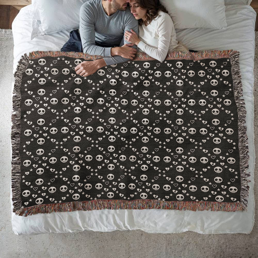 woven blanket with a geometric pattern of stitch mouth skulls