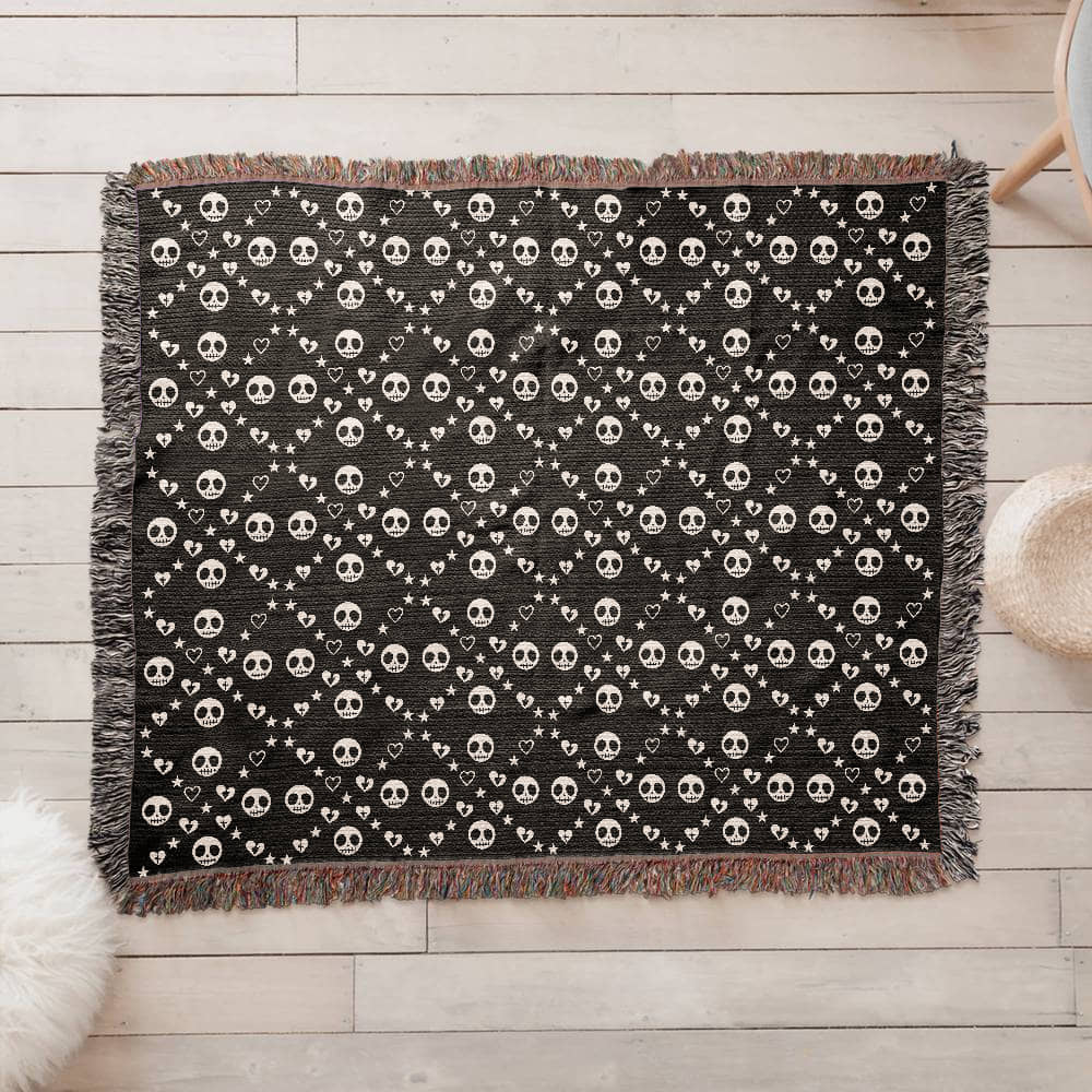 woven blanket with a geometric pattern of stitch mouth skulls