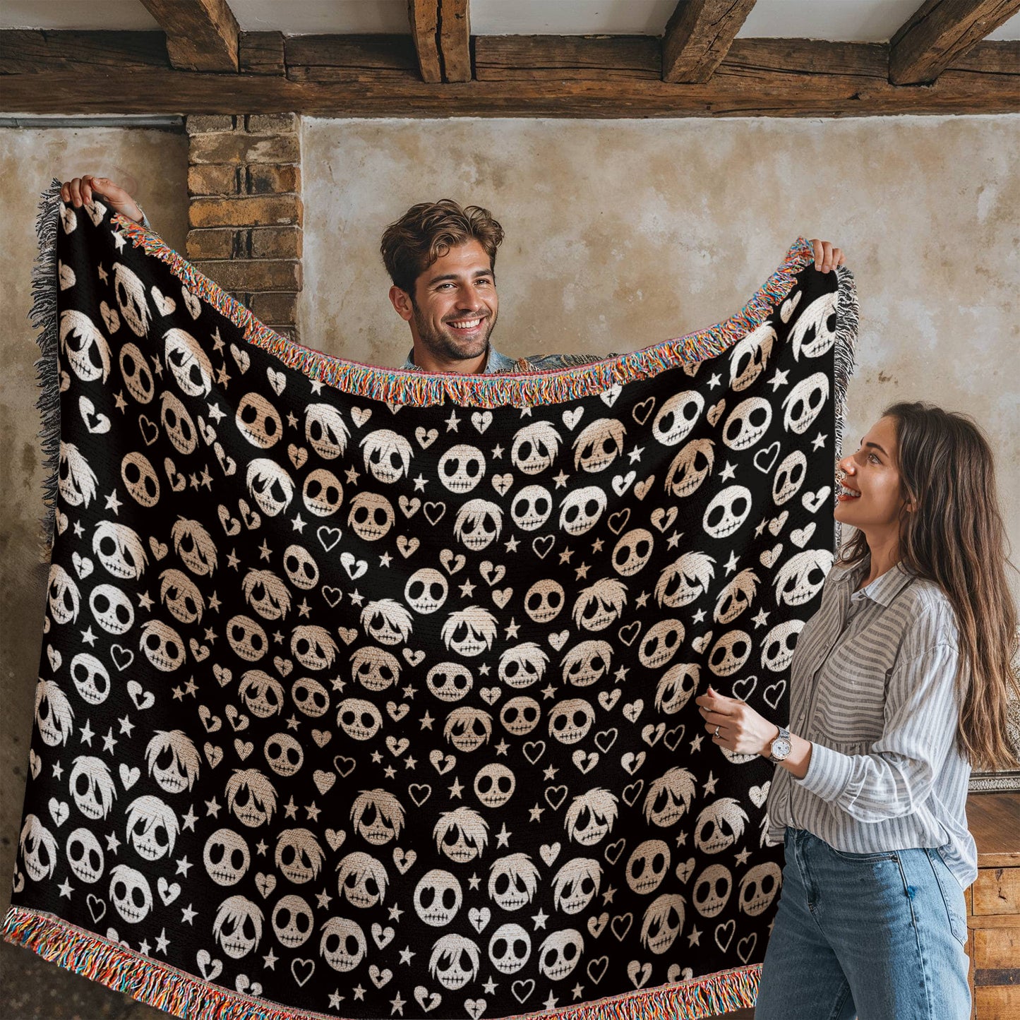 a woven blanket with a pattern of stitch mouthed emo ghouls and broken hearts on a dark background