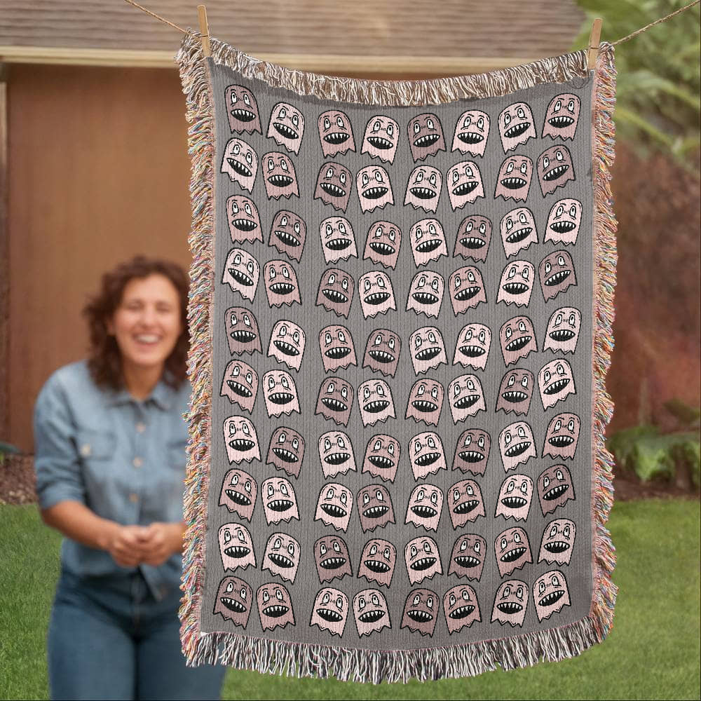 a woven blanket with a purplish grey and pink goblin pattern
