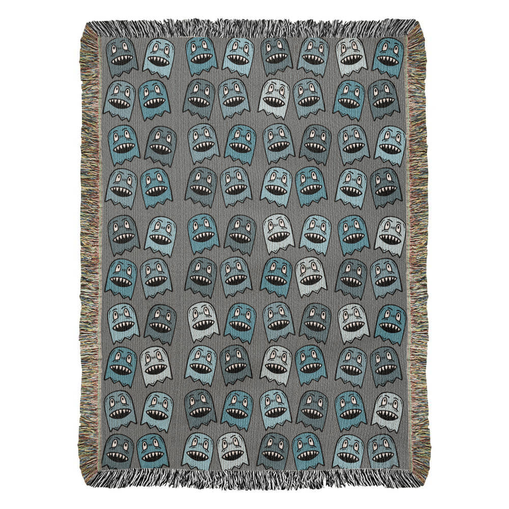 A woven blanket with grinning blue shade goblins on a grey background