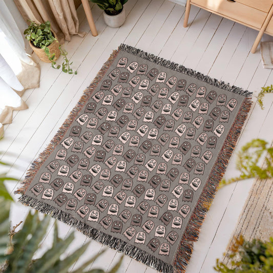 a woven blanket with a purplish grey and pink goblin pattern