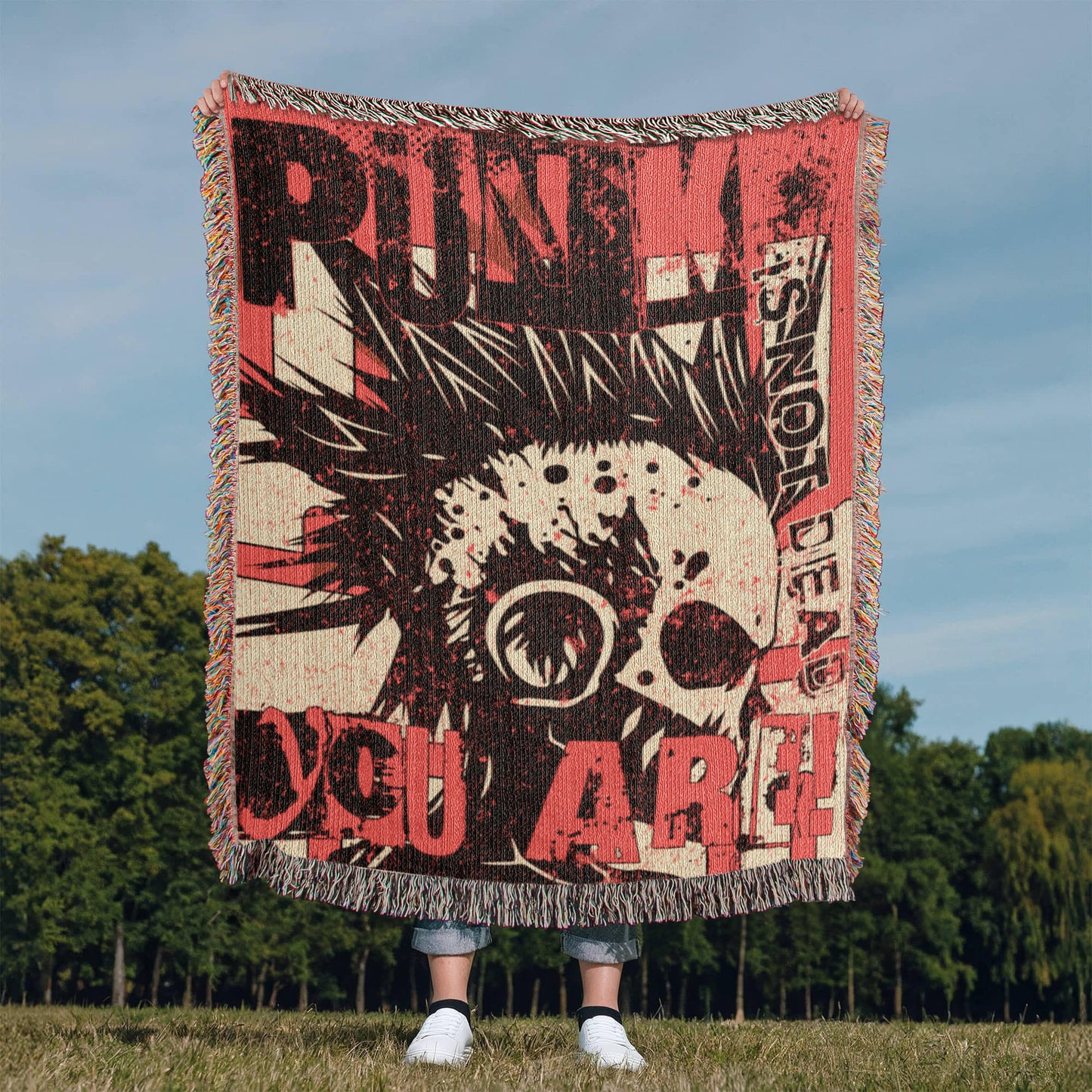 a woven blanket with a punk collage in pink and black, with text and a mohawk skull