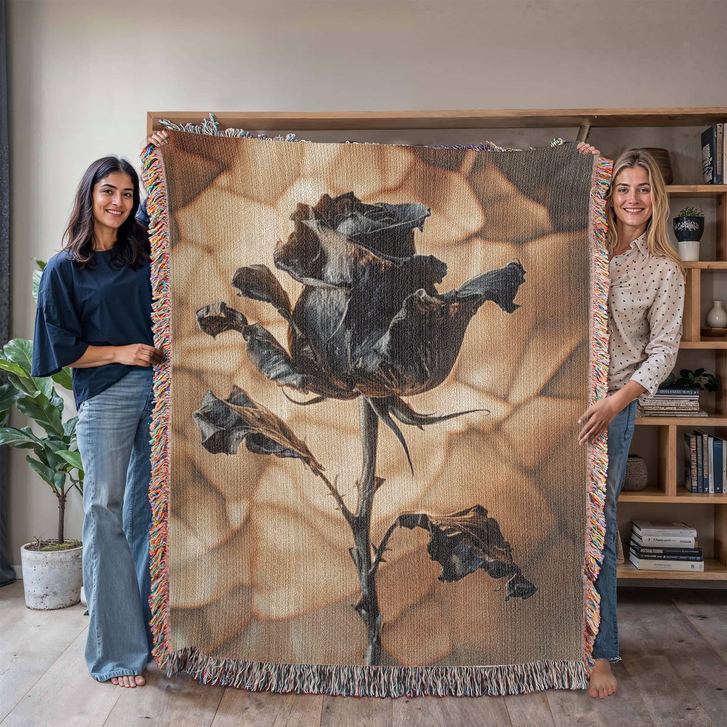 a woven blanket with a black wilted rose and shattered beige background