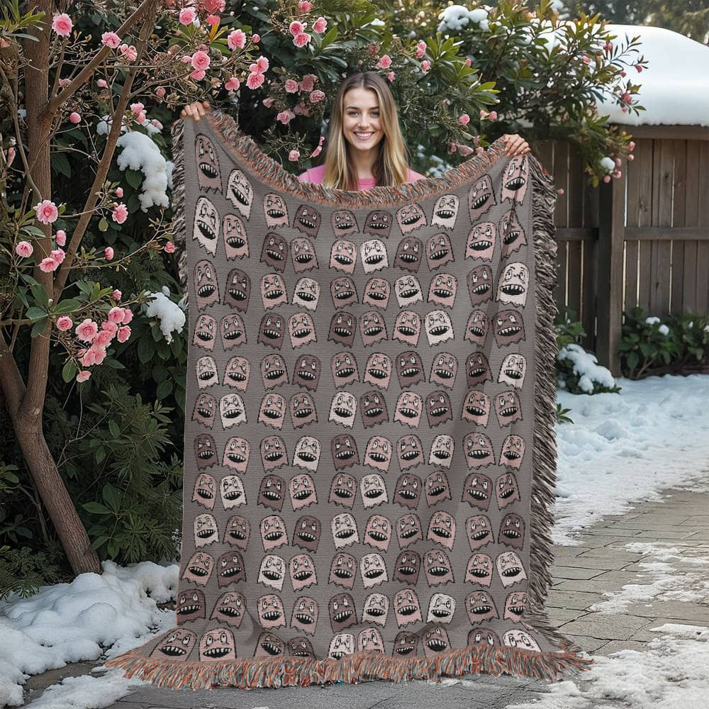 a woven blanket with a purplish grey and pink goblin pattern