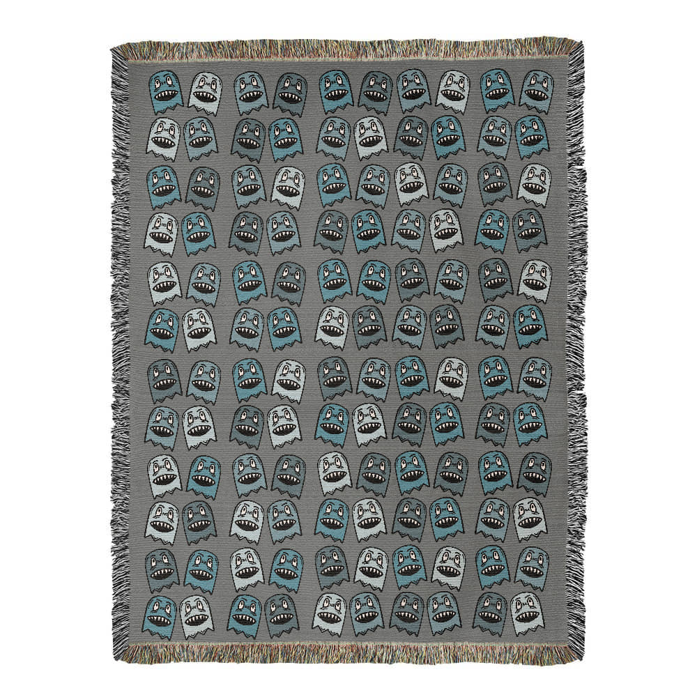 A woven blanket with grinning blue shade goblins on a grey background