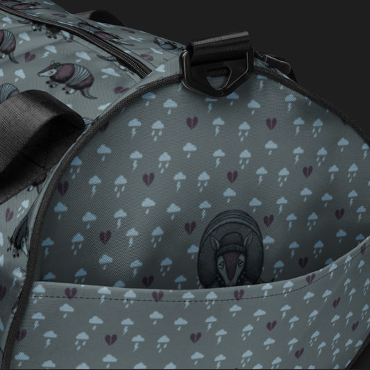 a duffel gym bag with an emo armadillo pattern with broken hearts and storm clouds