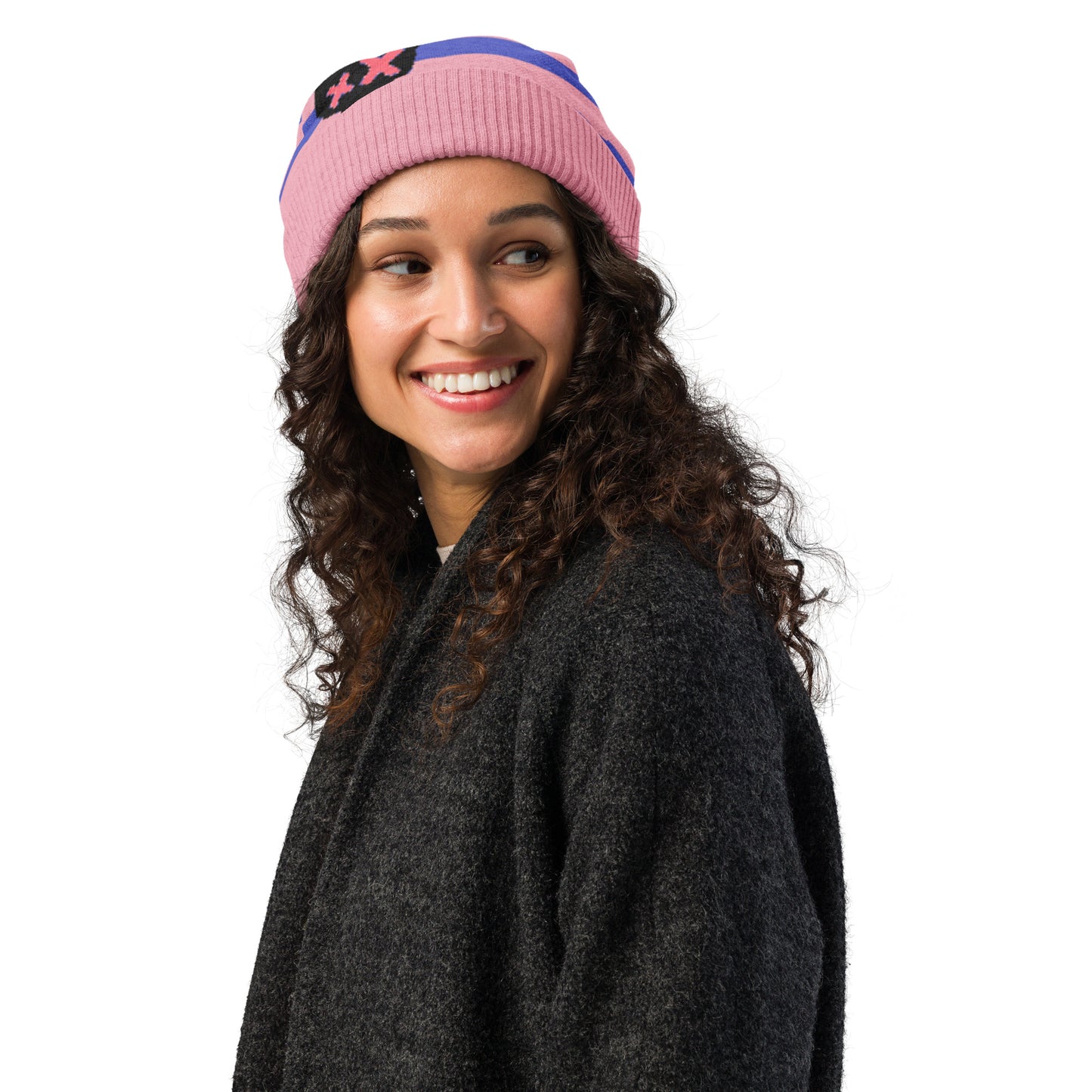 knitted beanie with a black grunge skull with x-eyes on a striped blue and pink background