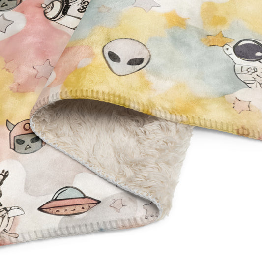 a pastel ice cream colored fleece sherpa blanket with space theme