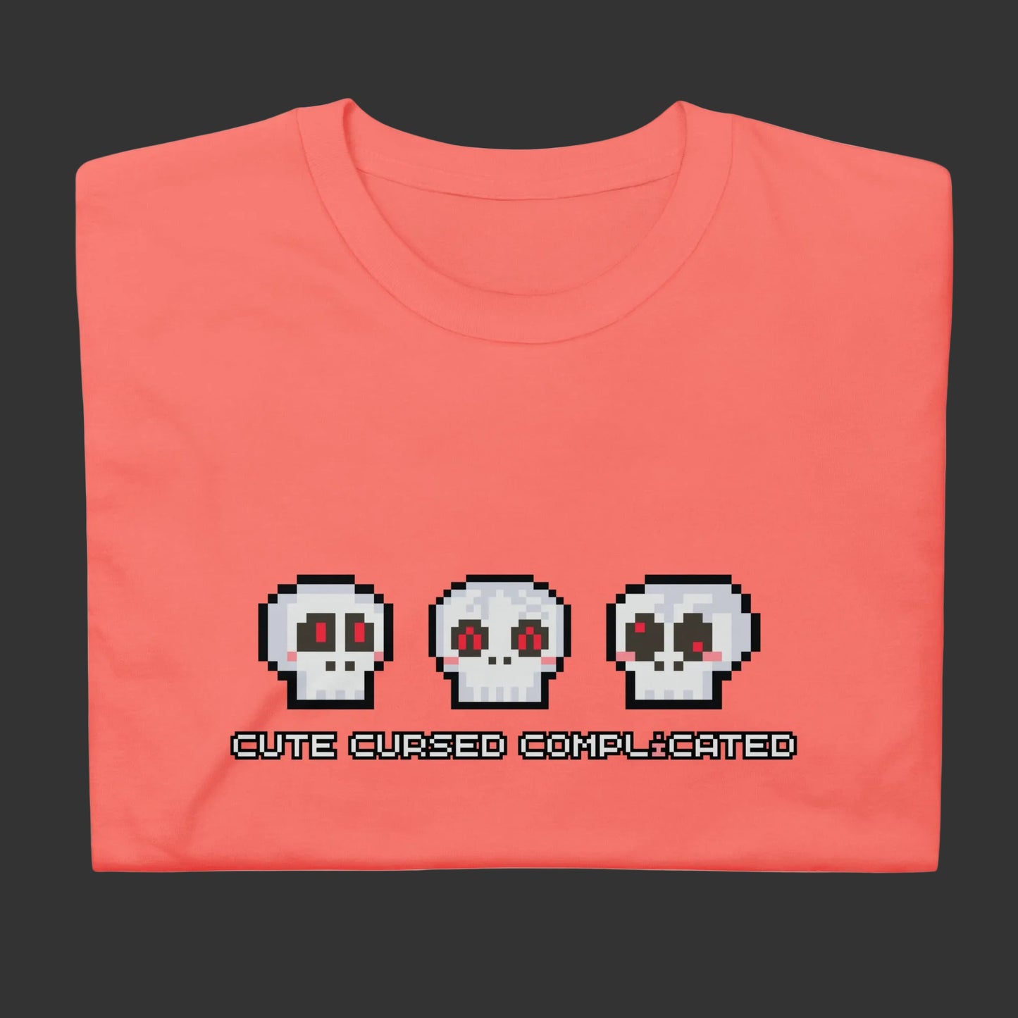 A t-shirt with pixel art skulls and text "cute cursed complicated"