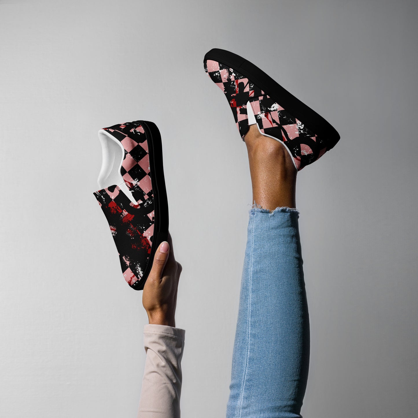 woman wearing slip on shoes with a pink and black distressed checker emo pattern
