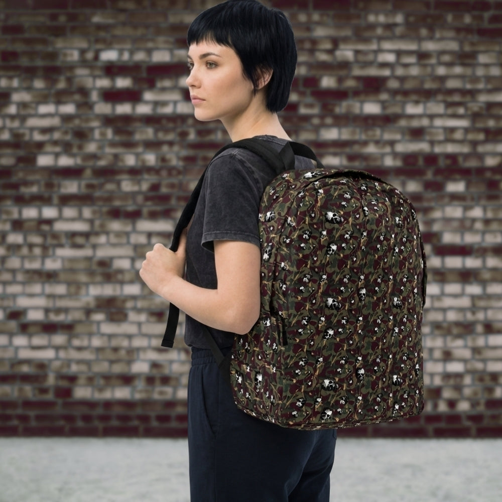Person wearing a backpack with a camo and paint and gritty skull pattern in burgundy and green shades