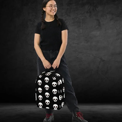 student girl carrying a backpack with a large skull pattern on black