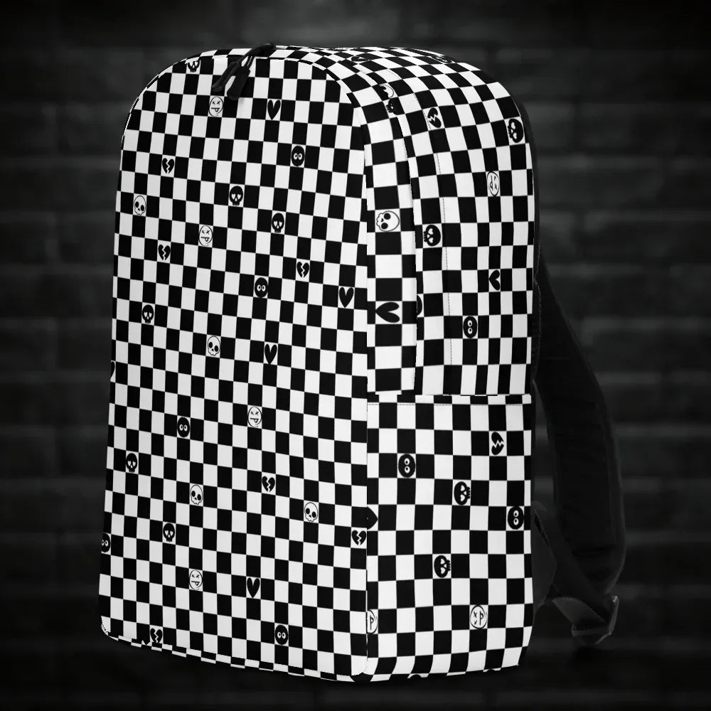A backpack with black and white checkers, and with emo symbols in some of the white squares 
