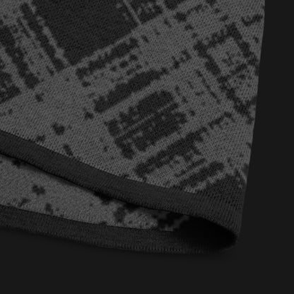 A dark black and charcoal broken plaid pattern knitted tee