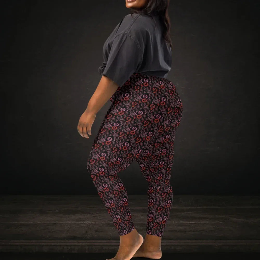 Person in plus size wearing leggings with skull and broken heart candy in burgundy pink and red