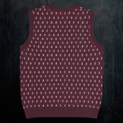 a burgundy knitted vest with crying pink flowers and droplets