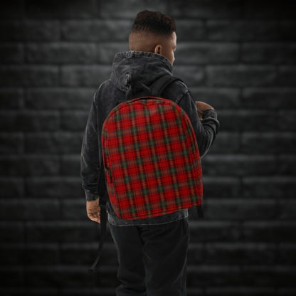 Person carrying a backpack with classic red punk tartan print