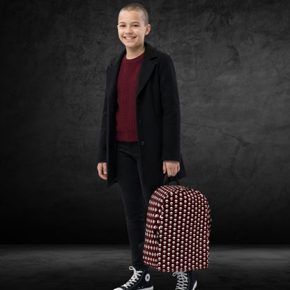Cool student girl carrying a backpack with a skull pattern on deep red