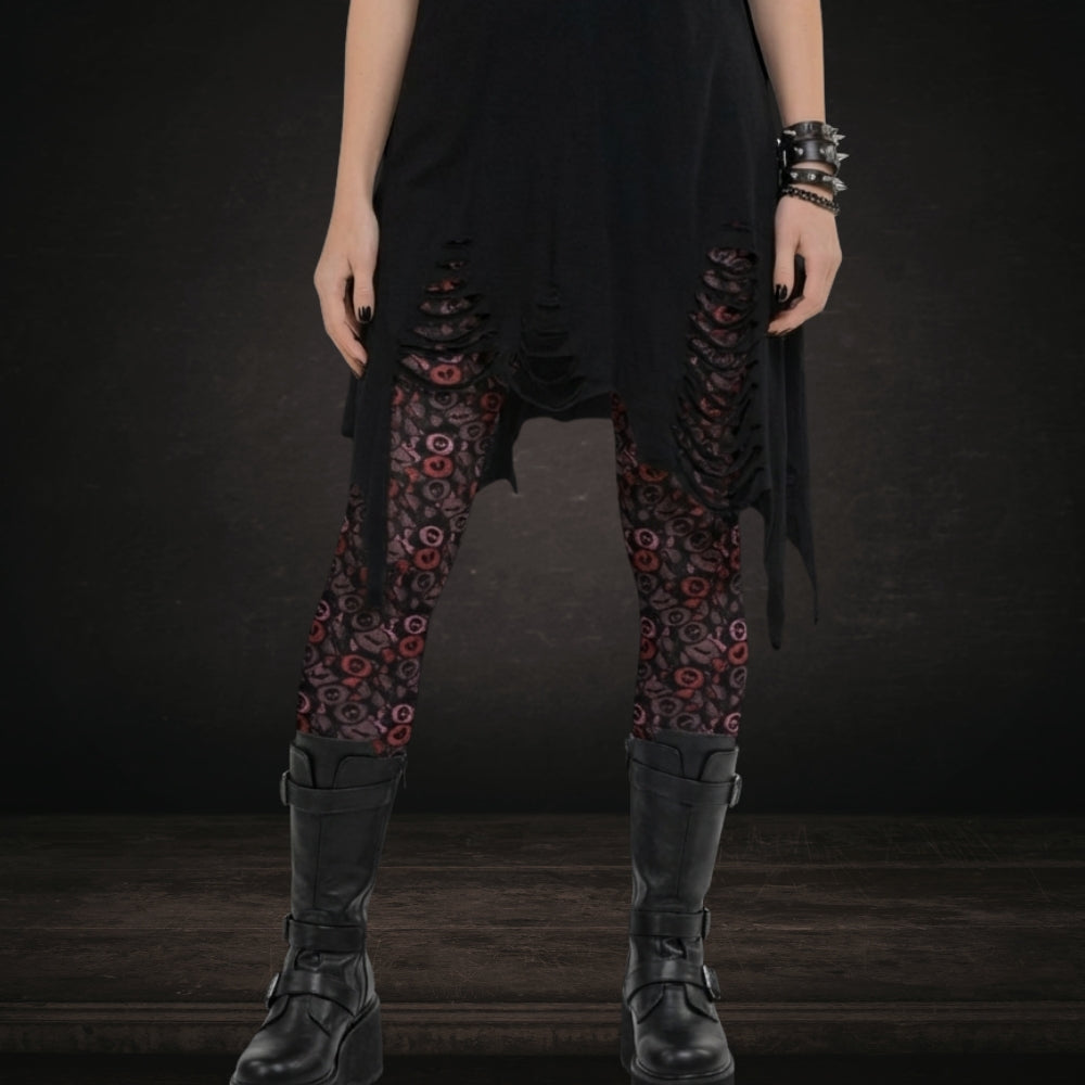 Gothic person wearing leggings with skull and broken heart candy in burgundy pink and red