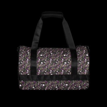 a duffel gym bag with a camo, paint splatter, and gritty skulls pattern in camo and purple shades