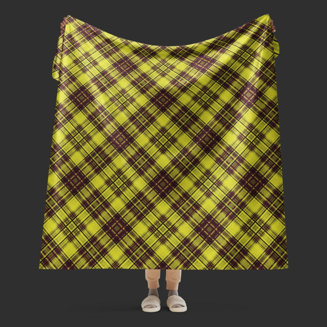A large fleece sherpa blanket with a a burgundy and mustard plaid pattern