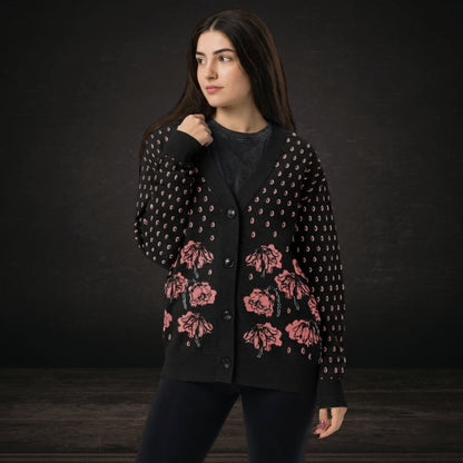 Person wearing an emotional black knitted cardigan with tears and crying flowers