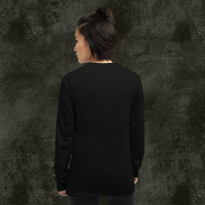 Person wearing a long sleeve tee with pixel art cute skulls and text "cute cursed complicated"