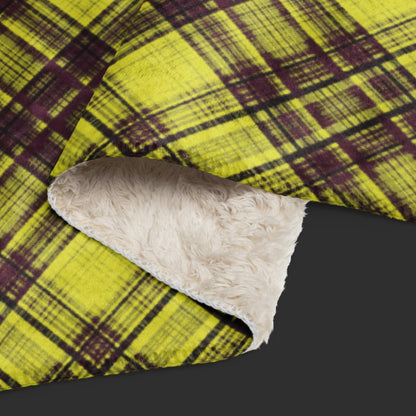 A large fleece sherpa blanket with a distressed burgundy and mustard plaid pattern