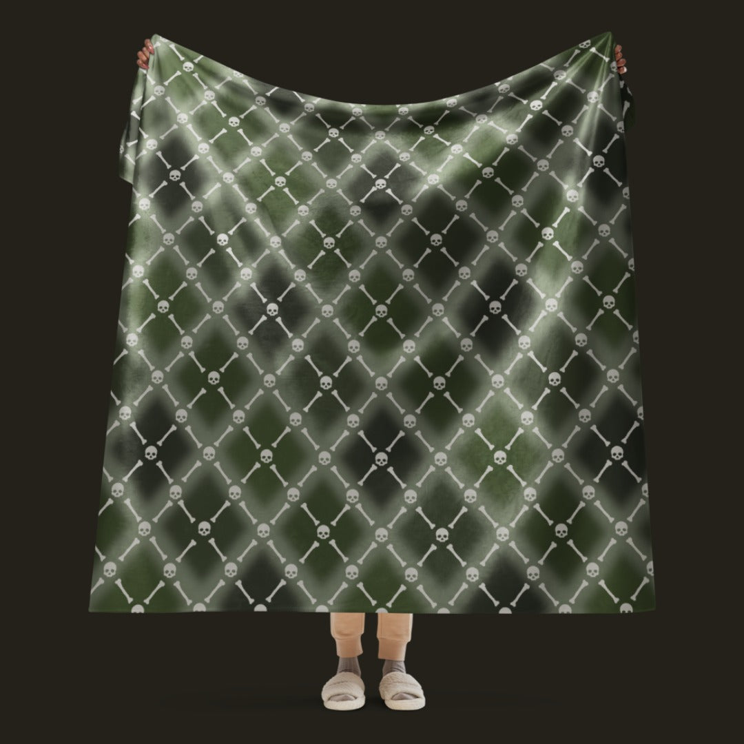 A fleece sherpa blanket with a soft argyle pattern and skulls and bones diagonals