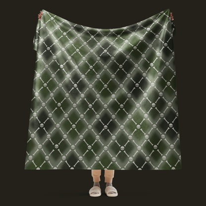 A fleece sherpa blanket with a soft argyle pattern and skulls and bones diagonals