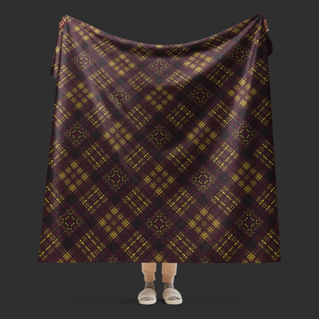 A large fleece sherpa blanket with a a deep burgundy and mustard plaid pattern