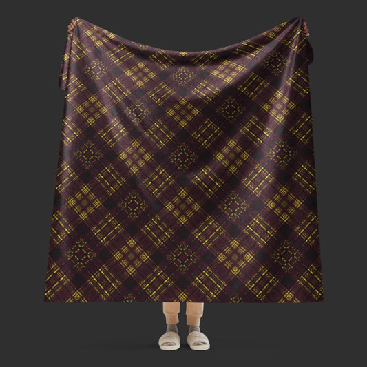 A large fleece sherpa blanket with a a deep burgundy and mustard plaid pattern