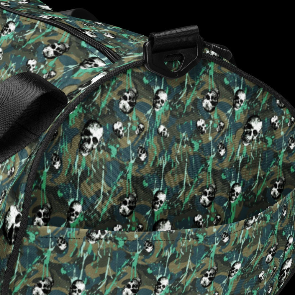 a duffel gym bag with a camo, paint splatter, and gritty skulls pattern in camo and teal shades
