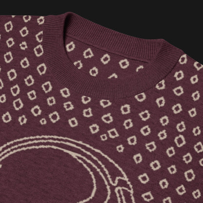 A burgundy short sleeve knit featuring a line art skull with headphones and hand drawn diamonds