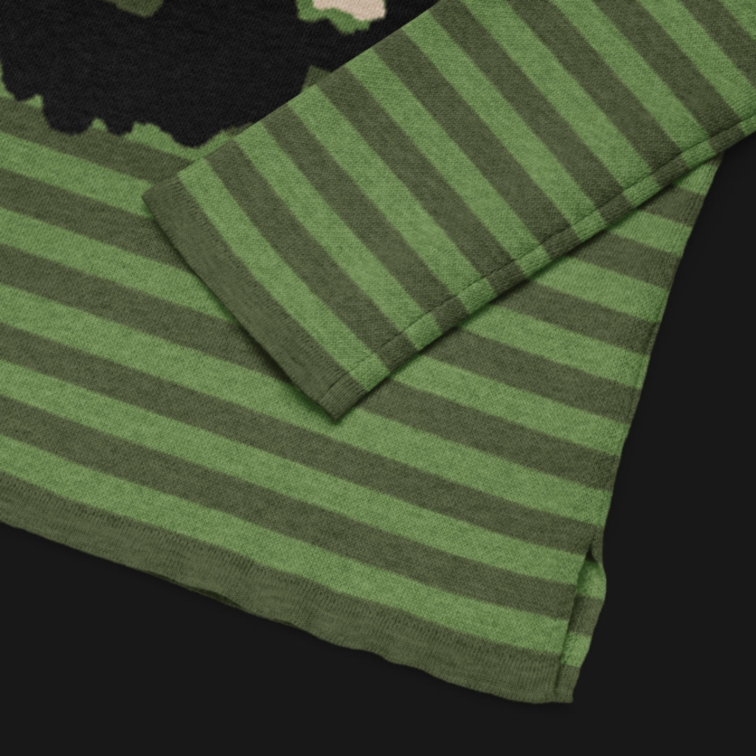 Green striped sweater with a large x-eyed skull design