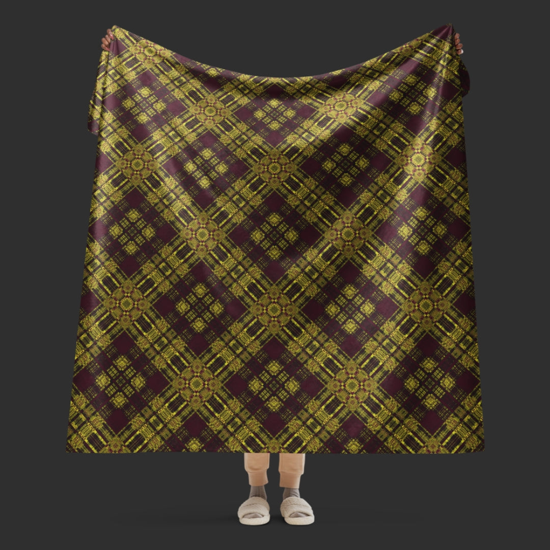 A large fleece sherpa blanket with a a deep burgundy and mustard plaid pattern