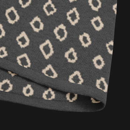 A grey short sleeve knit featuring a line art skull with headphones and hand drawn diamonds