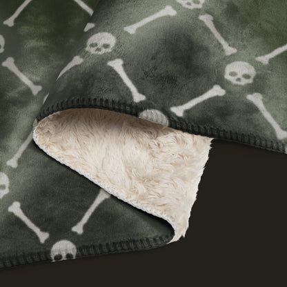 A fleece sherpa blanket with a soft argyle pattern and skulls and bones diagonals