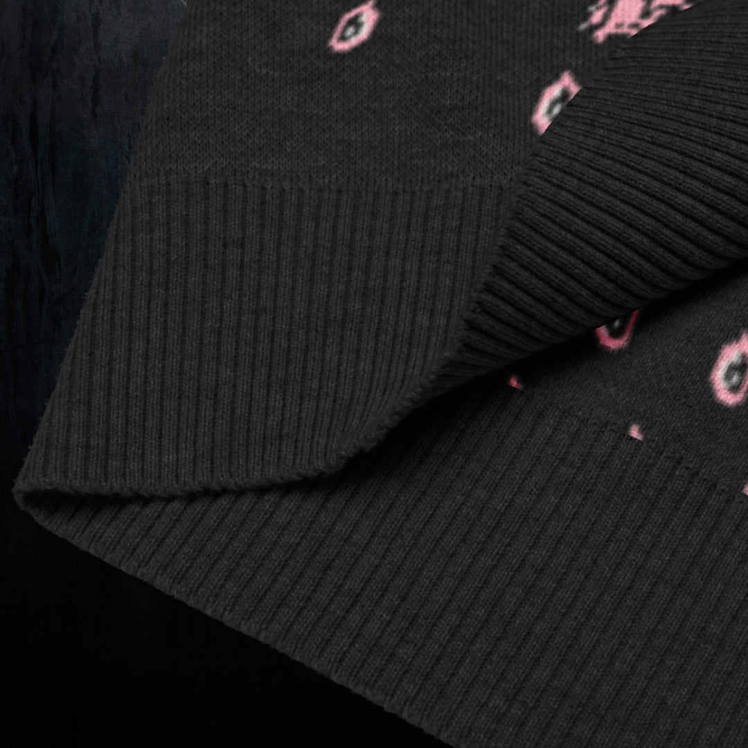 a black knitted vest with crying pink flowers and droplets