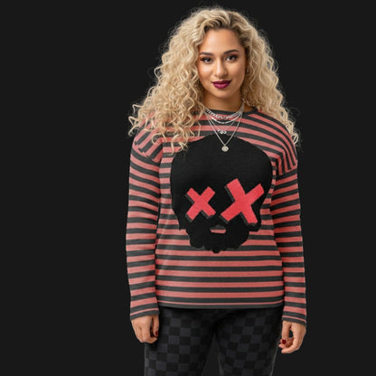 alt style girl wearing a striped charcoal and pink knit sweater with a large skull with x-eyes