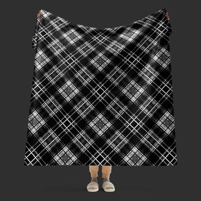 Large fleece sherpa blanket with a fuzzy distressed plaid pattern in black and white.
